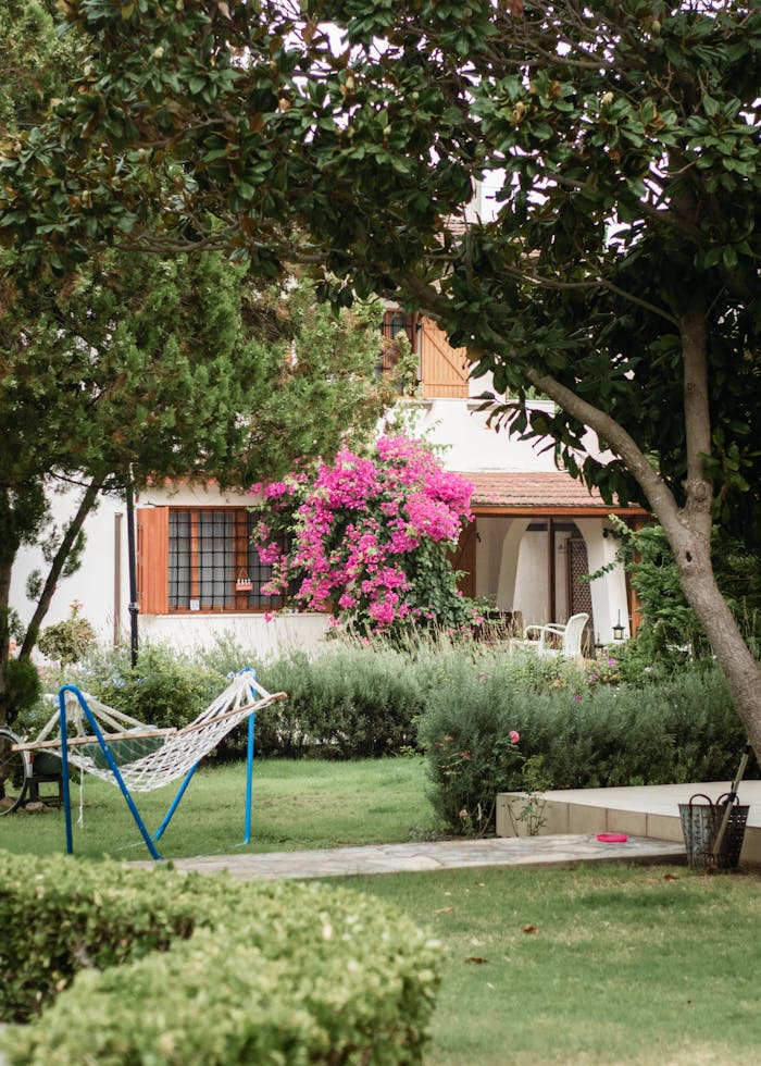 A hammock is in the middle of a garden